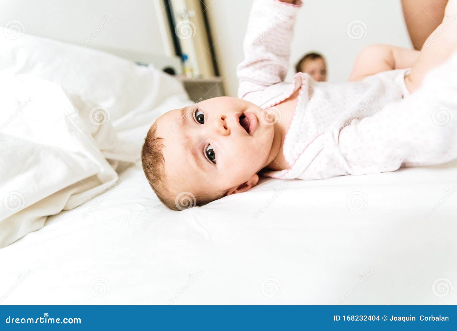 Naked Surprised Baby-girl Sitting On Brown Bed Stock Image 
