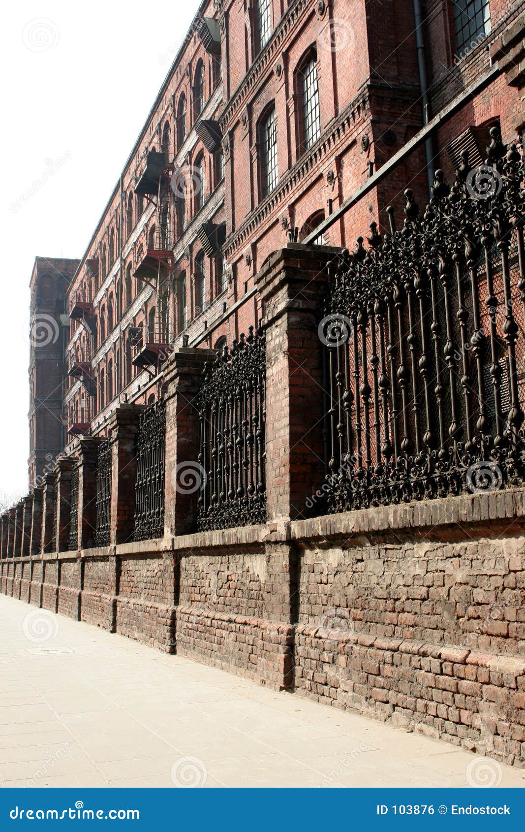 monumental, old factory behind the wall