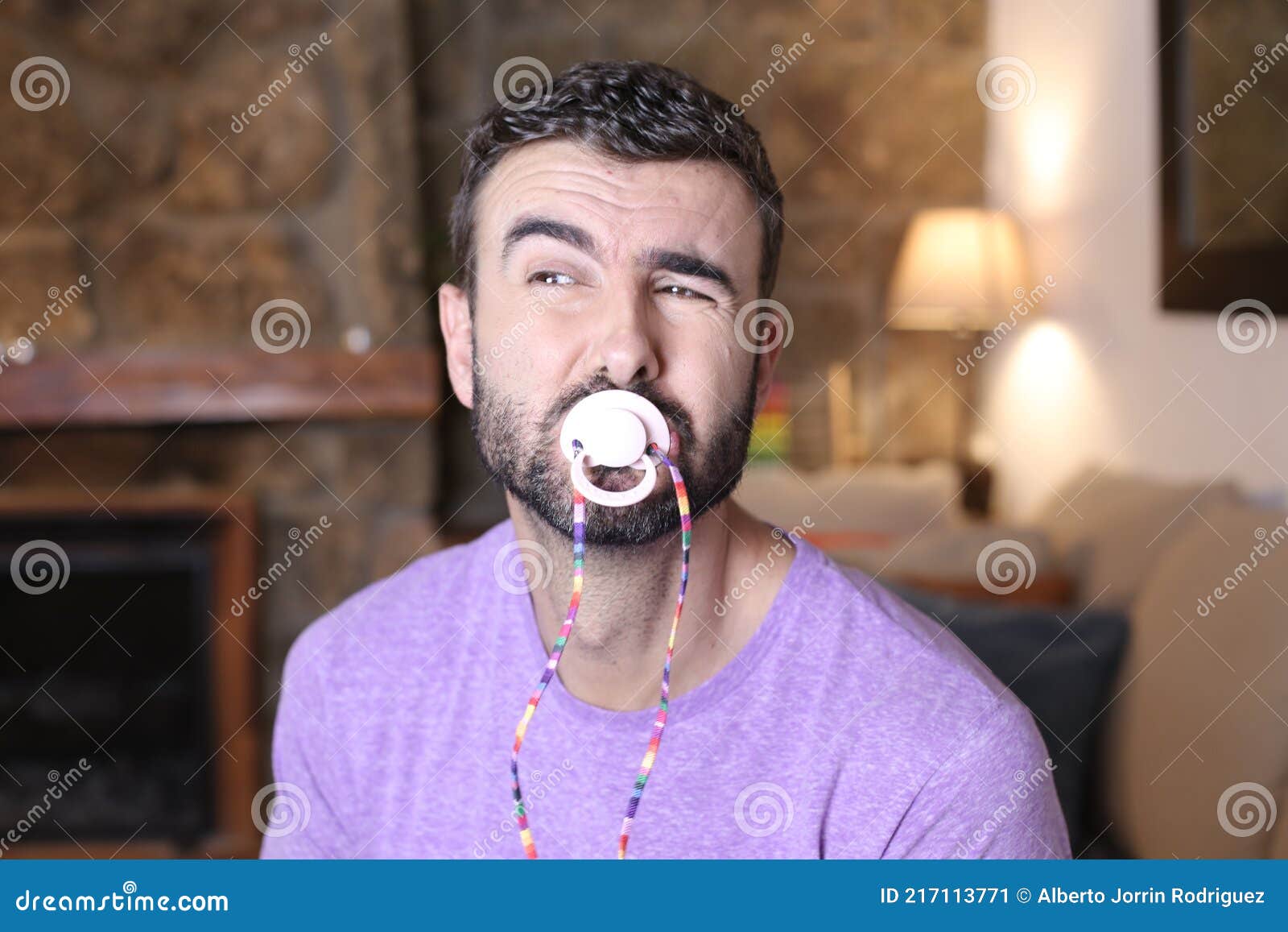 Moody man using a pacifier stock image. Image of male 217113771