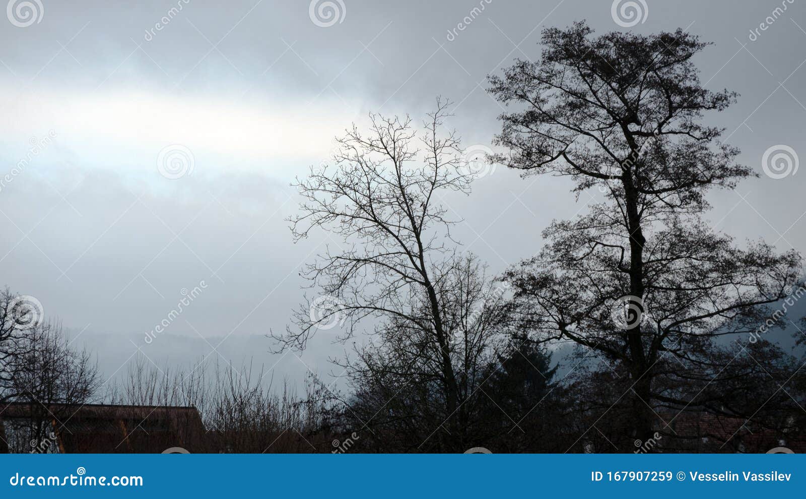 Moody Weather with Blue Sky Sections and Dark Clouds. Stock Image