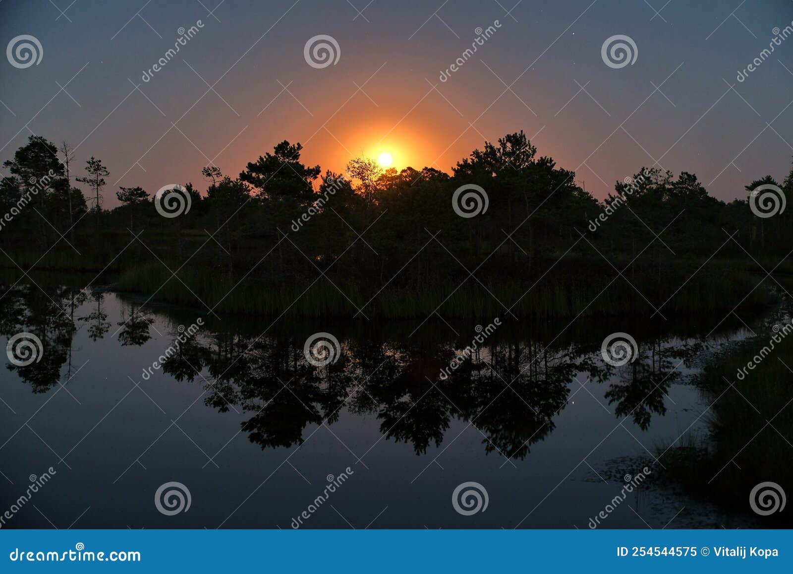 moon set observingn over lake in latvia