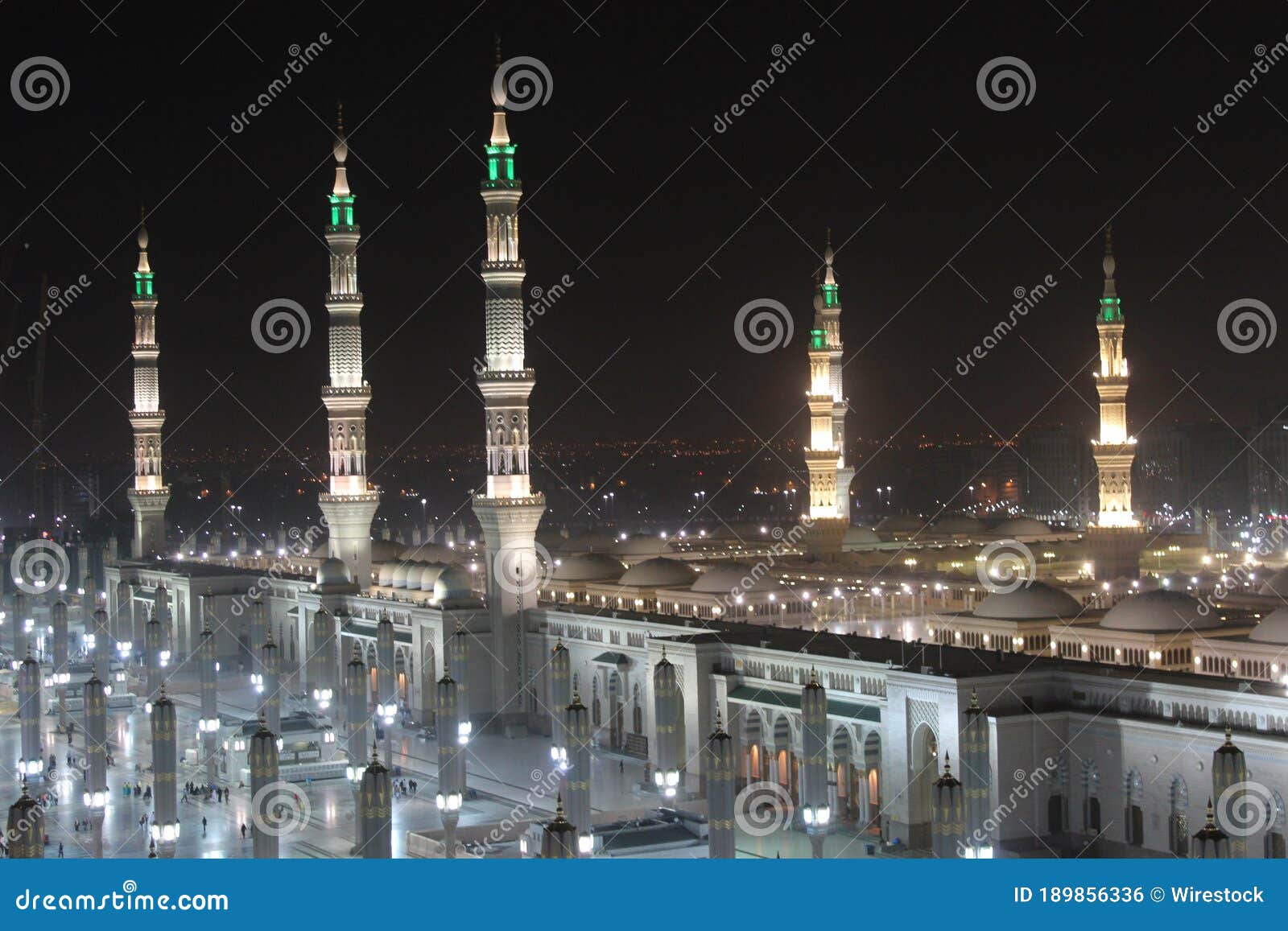 moon between two towers of the prophet's mosque in al madinah, saudi arabia