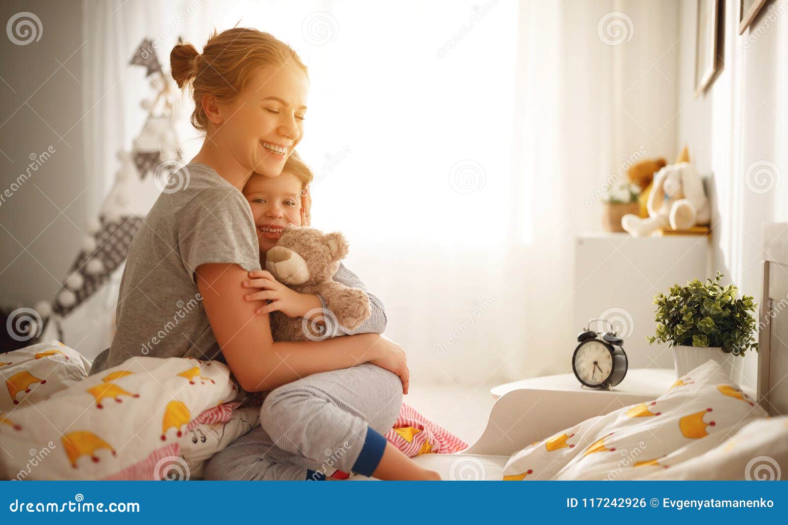Mother Wakes Her Daughter In Bed In Morning Stock Photo Image Of
