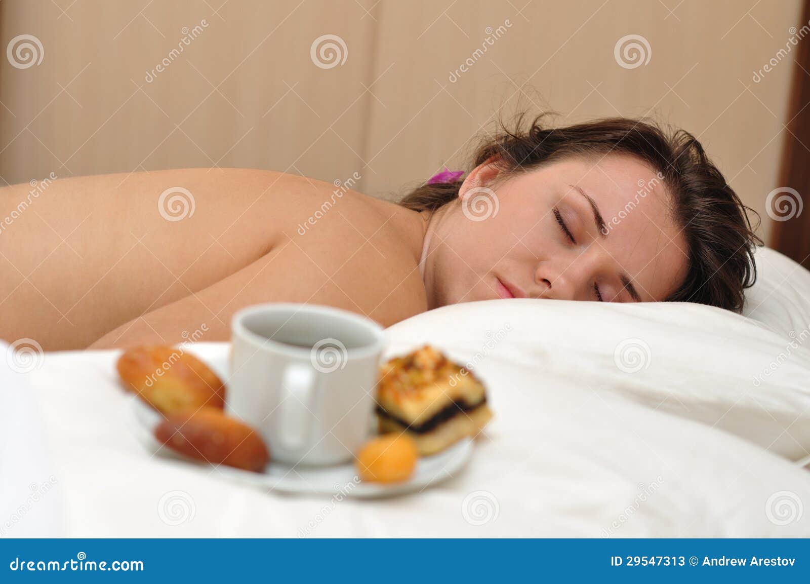 Morning coffee in a bed. The girl sleeps near morning coffee