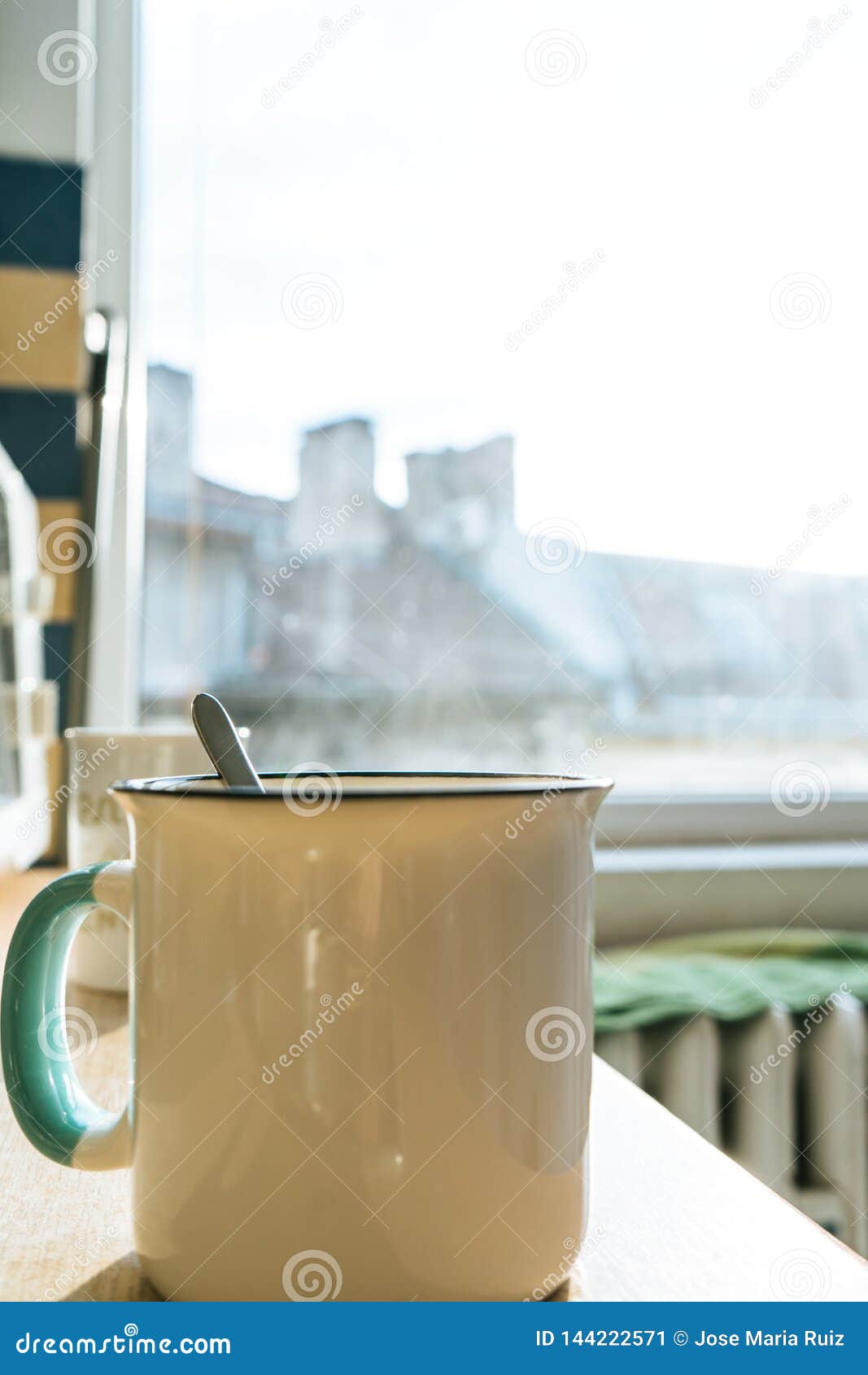 Morning Coffee Cup with a Teaspoon in a Kitchen with Sunrise and