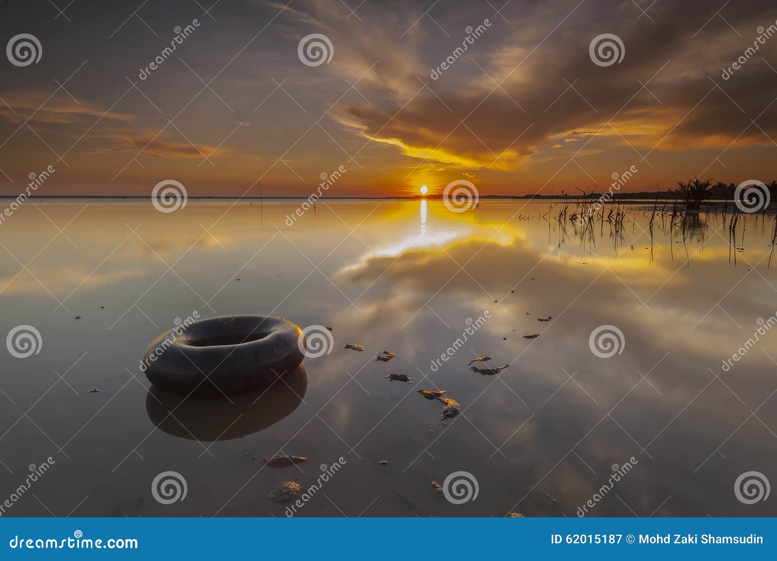 morning float with reflection during summer sunrise at terengganu beach