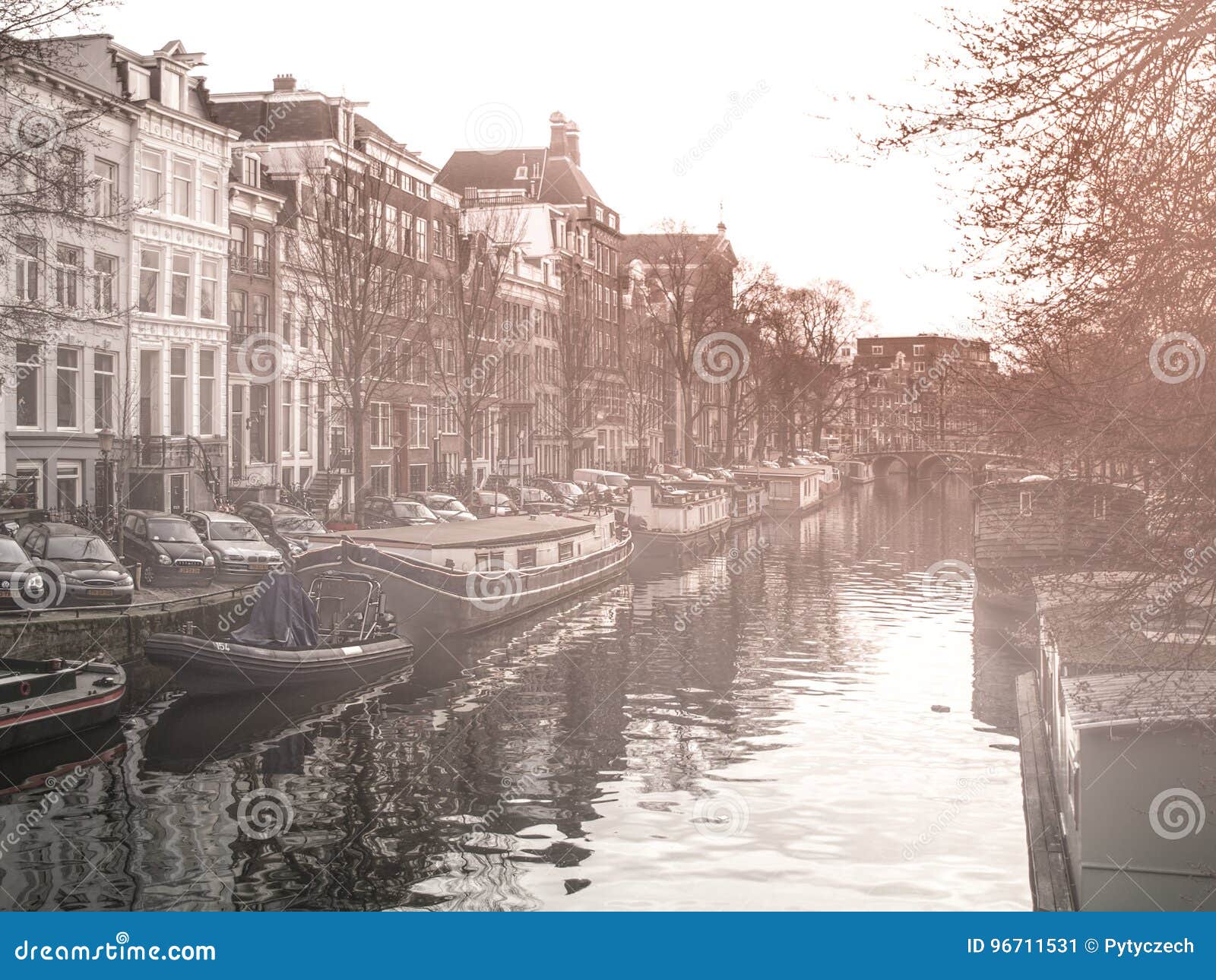 morning haze at water canal, gracht, in amsterdam, netherlands.