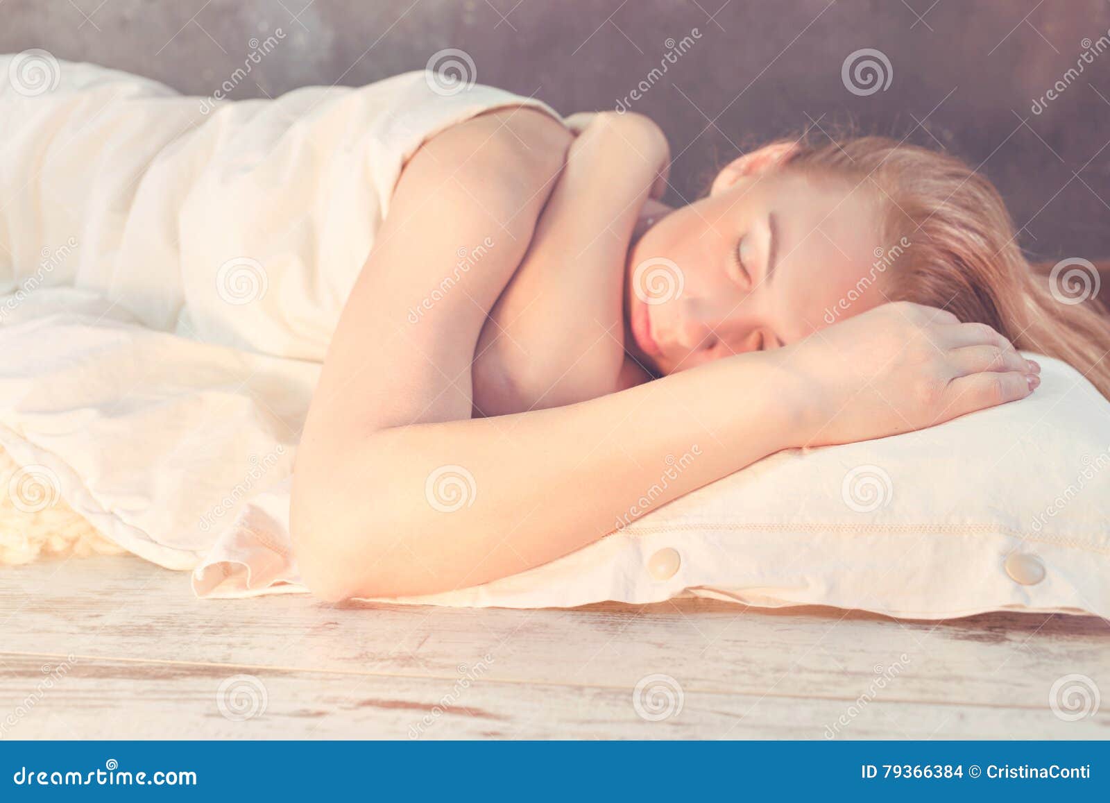 morning light illuminates woman sleeping in bed