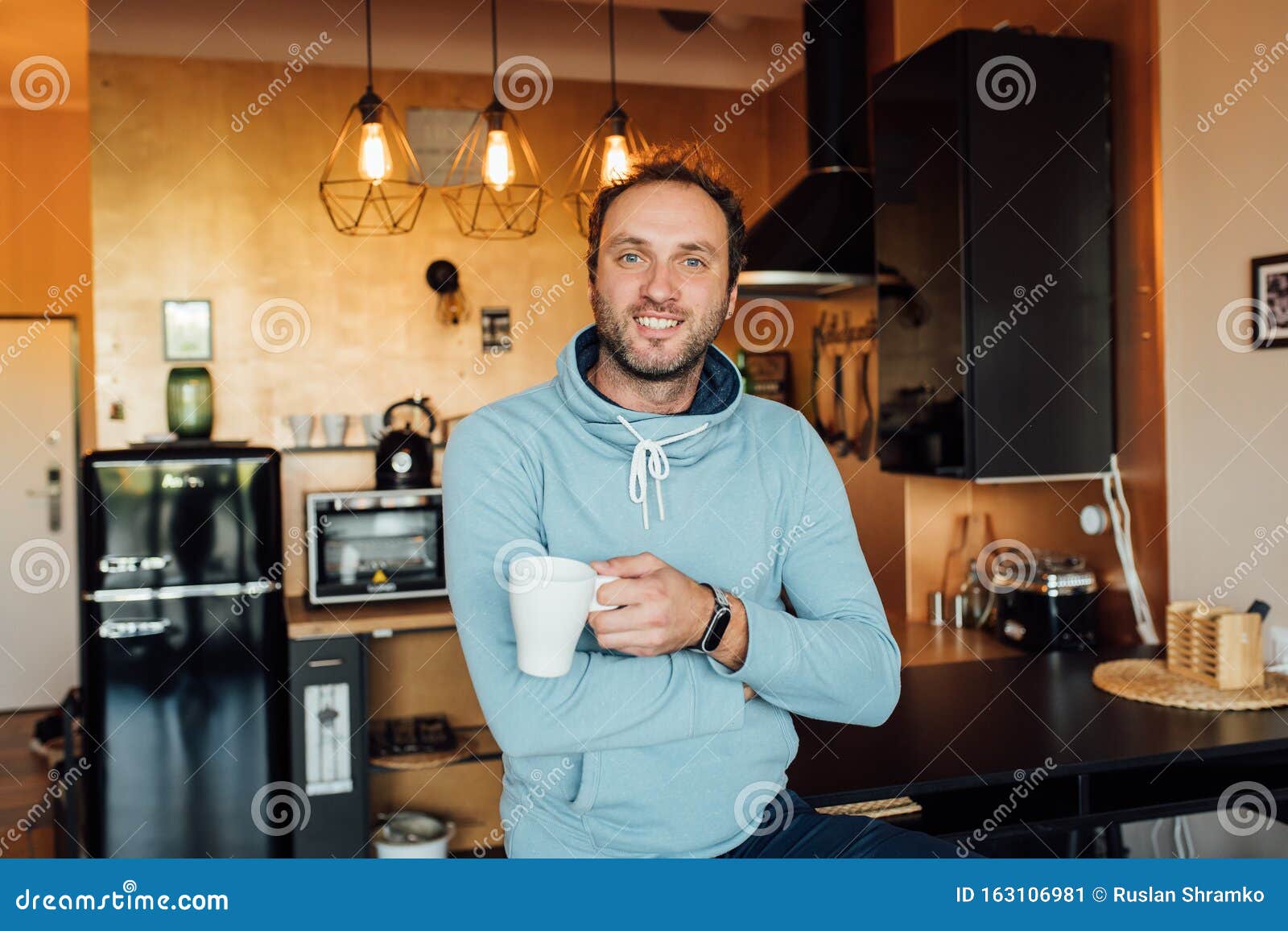 Morning News. Handsome Young Man Drinking Coffee at Home in the Loft ...