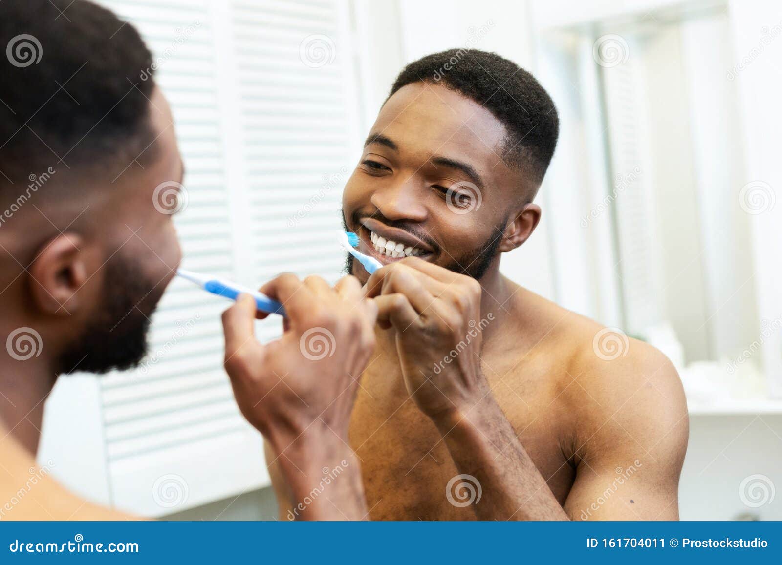 Millennial Black Guy Brushing His Teeth in Bathroom Stock Image Image