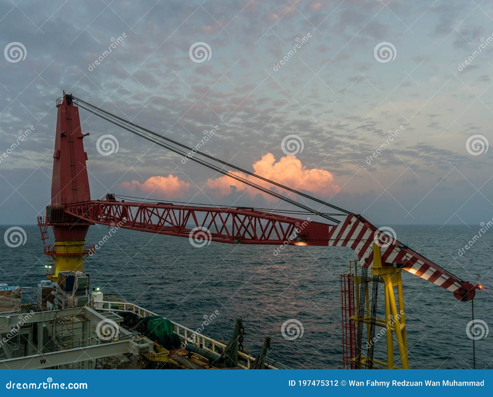 A typical accommodation construction work barge at oil field. A morning scenery of an offshore crane rested on boom rest onboard a typical accommodation construction work barge anchored at offshore Terengganu oil field while performing a hook-up and commissioning project