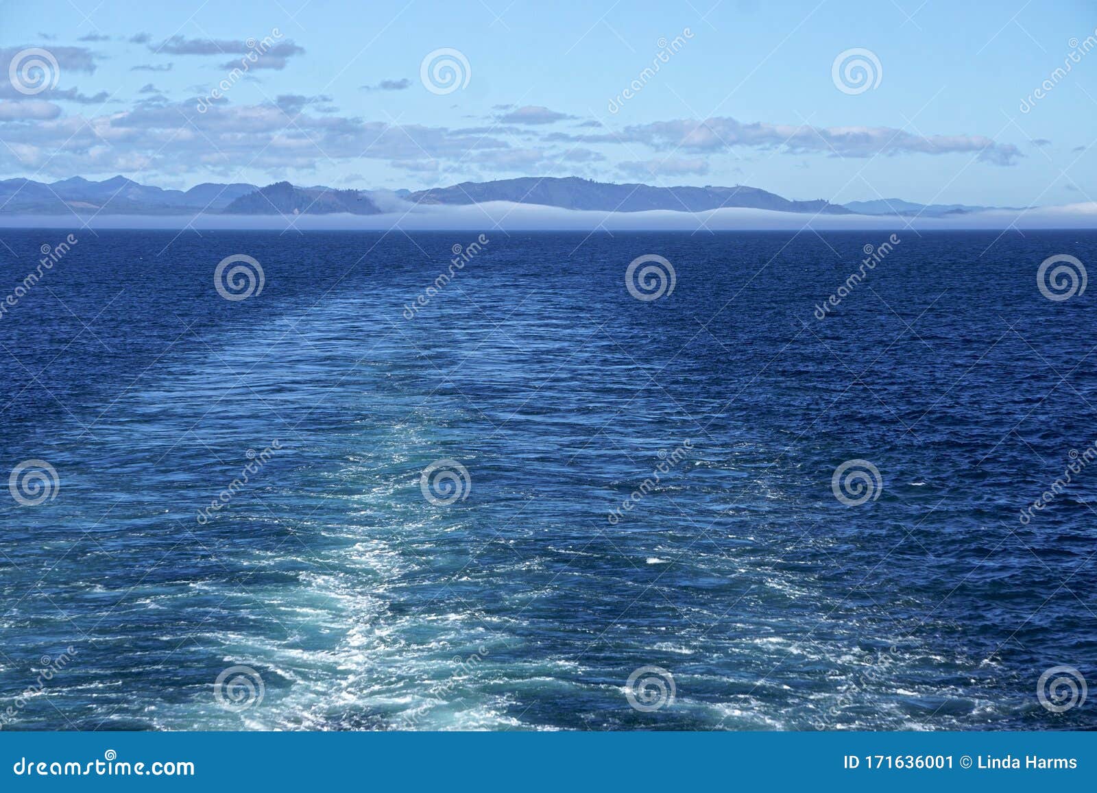 Morning At Sea Clouds And Fog In A Deep Blue Sky Over Alaskan Islands