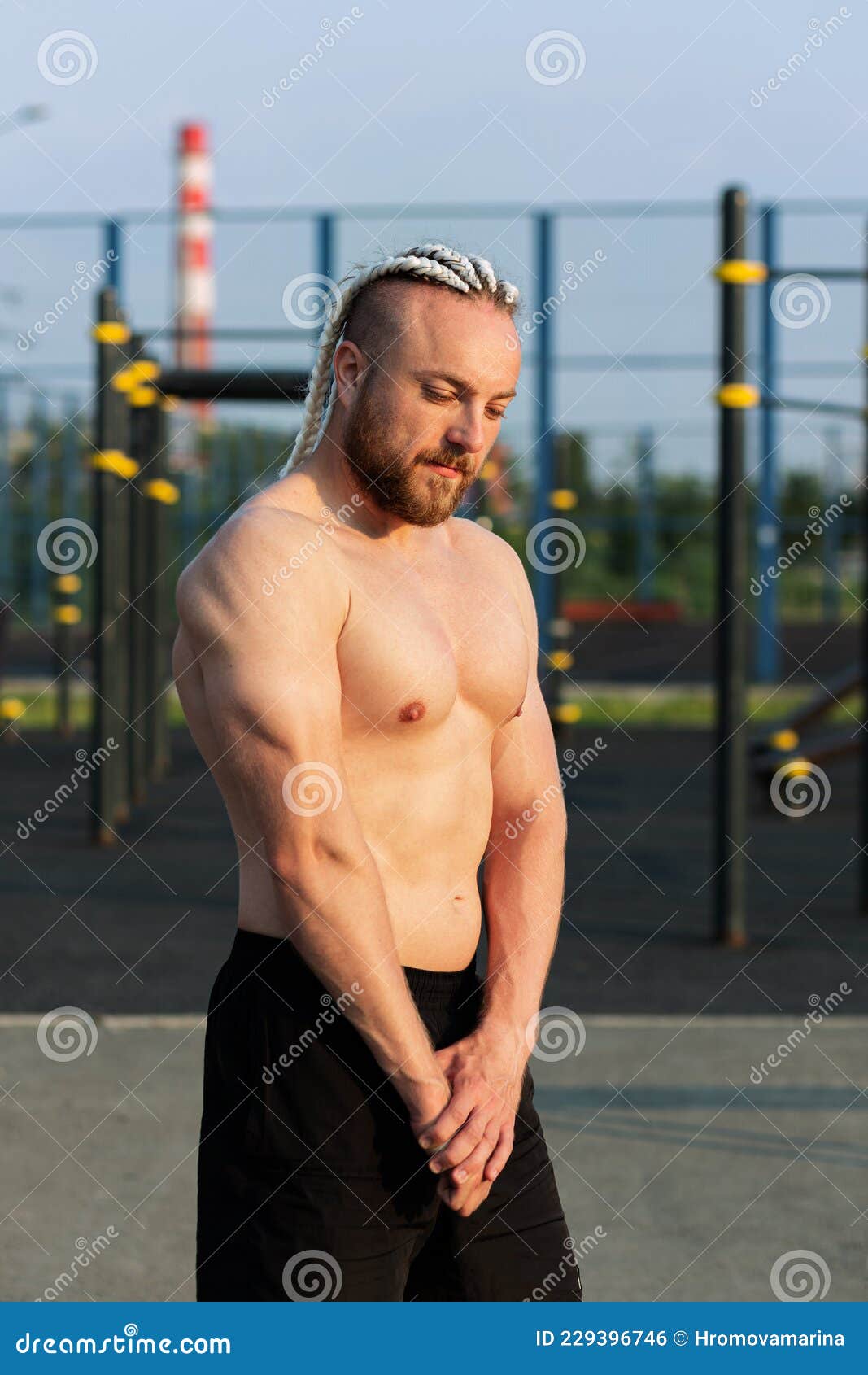 In the Morning at Sunrise, a Man with an Interesting Braid Hairstyle Poses  Like a Bodybuilder with a Naked Torso Stock Photo - Image of bodybuilding,  attractive: 229396746