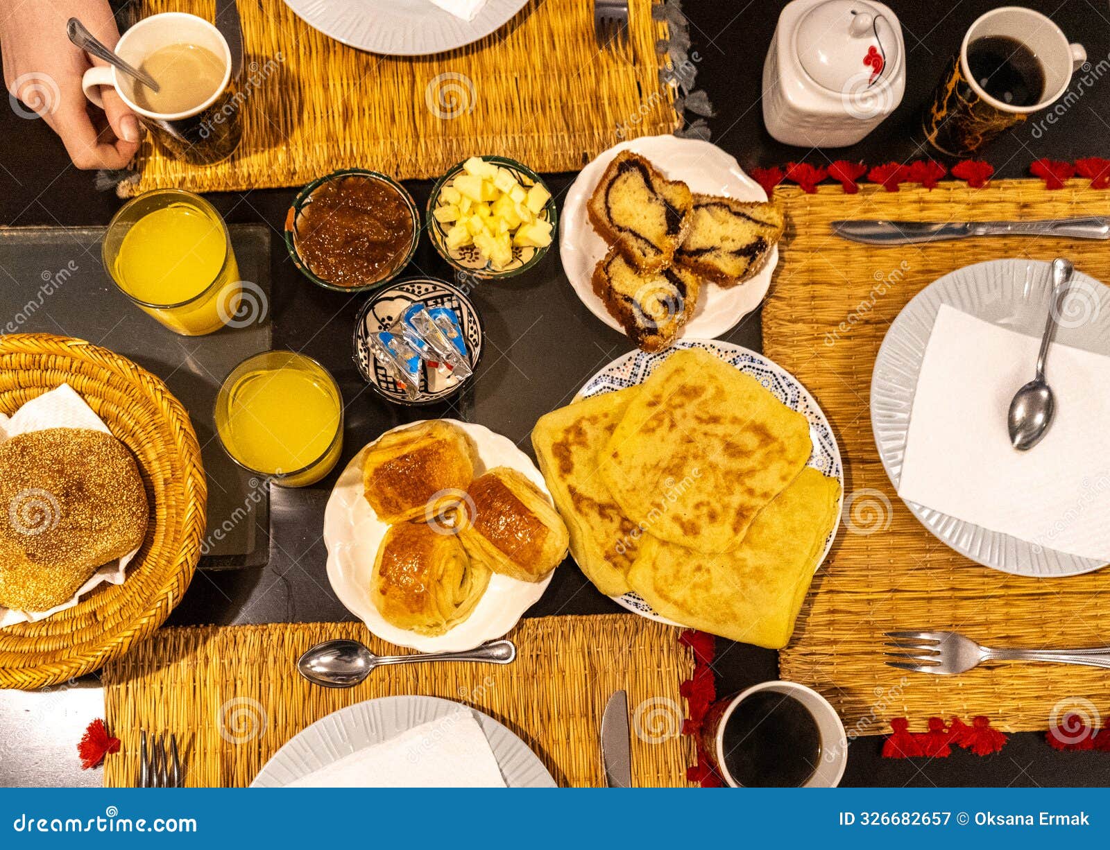 moroccan breakfast ftour, msemen, baghrir, orange juice, pastries, bread basket, fried eggs, cheese cubes