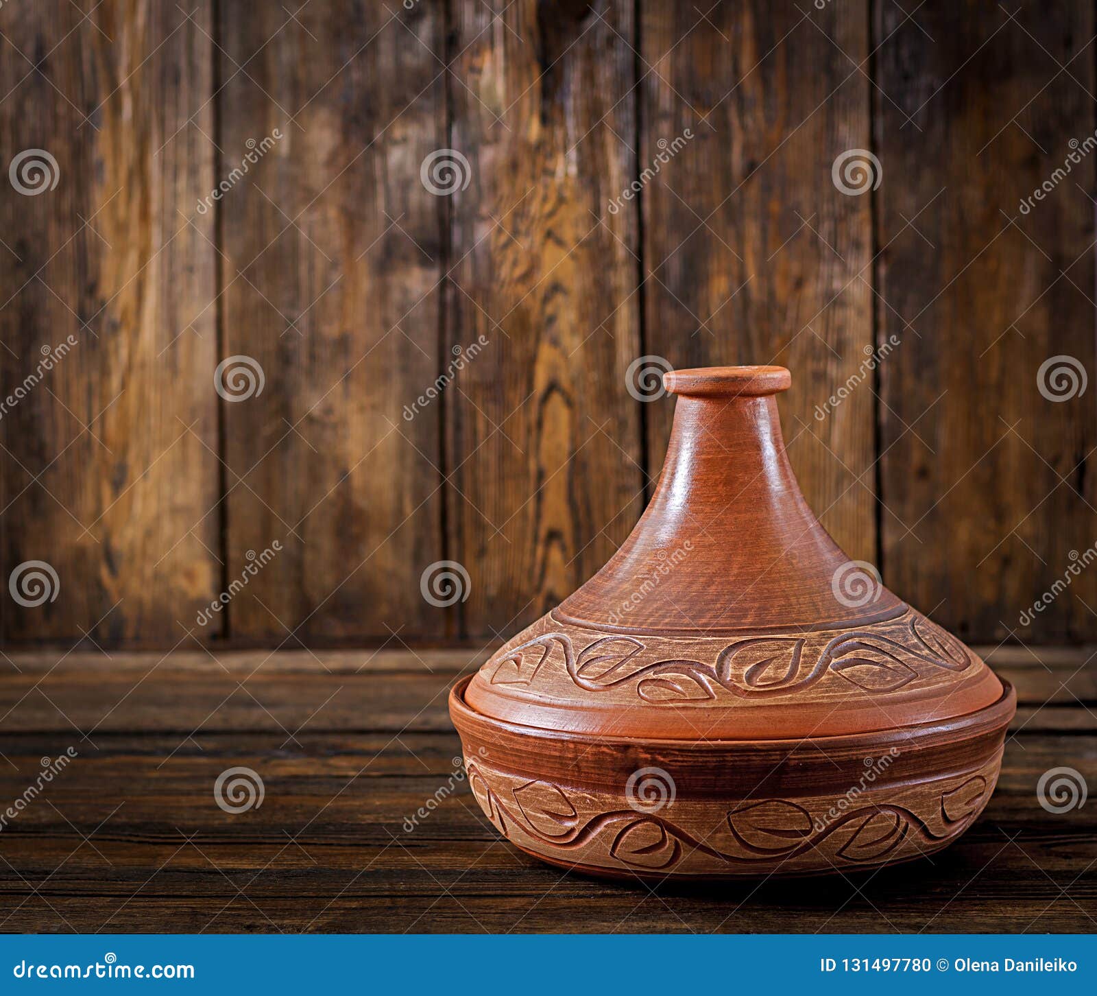 Moroccan Tagine Cooking Vessel on a Wooden Table. Copy Space Stock