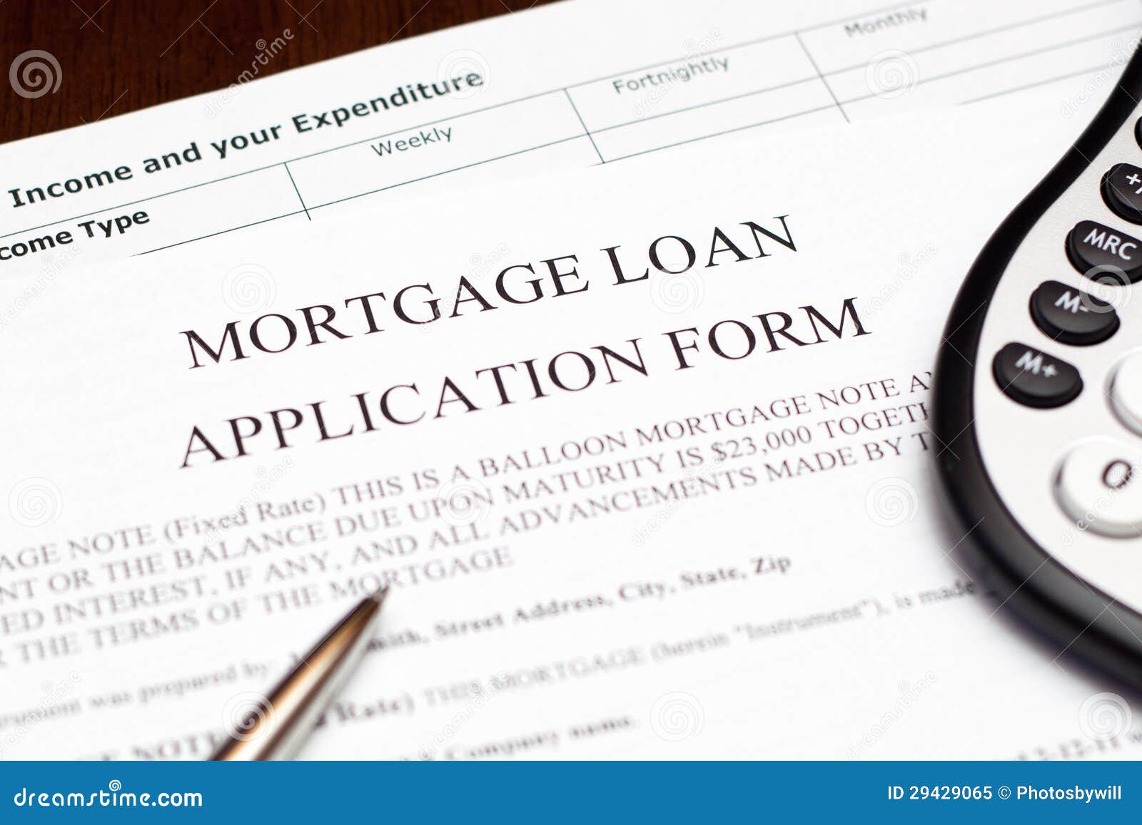 Mortgage Loan Application Form. Mortgage loan application from with a pen and calculator.