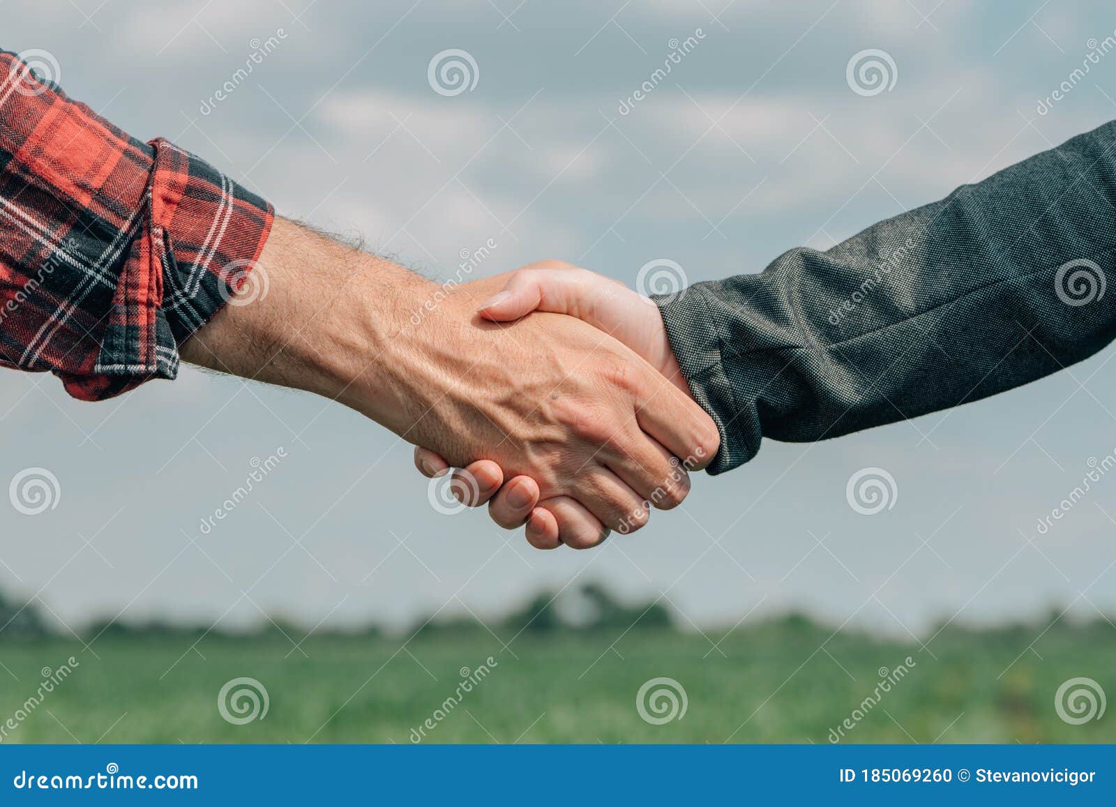mortgage loan officer and farmer shaking hands upon reaching an agreement