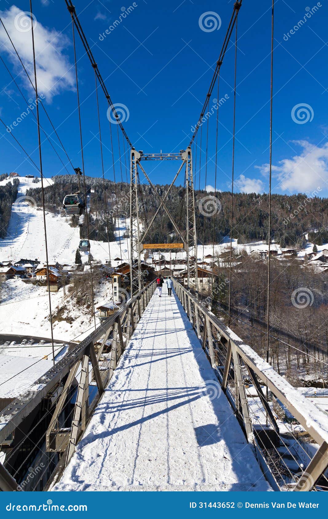 Morzine bridge. Suspension bridge connecting the village of Morzine, France, on a sunny winter day