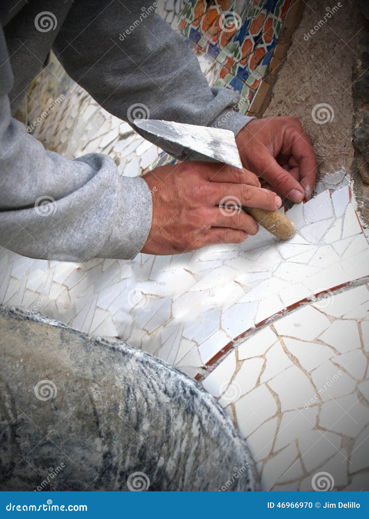 mosaic worker lays tiles