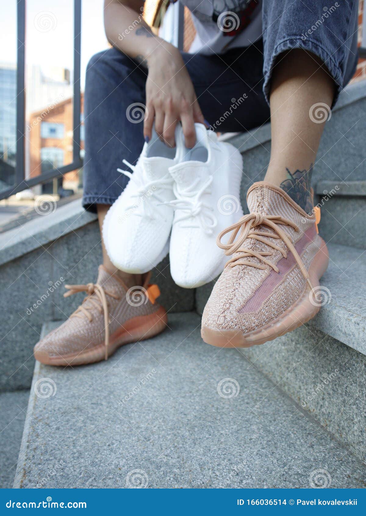 A Girl In Jeans And Cream Adidas Yeezy 