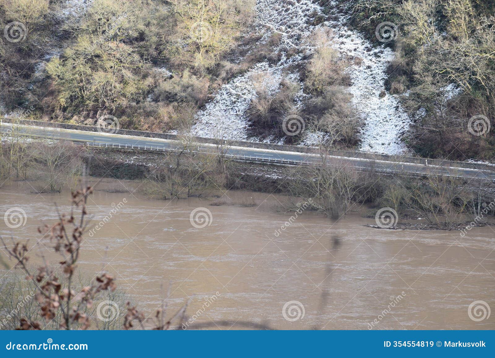 moselkern, germany - 01 10 2025: mosel flood with a clear road and snow