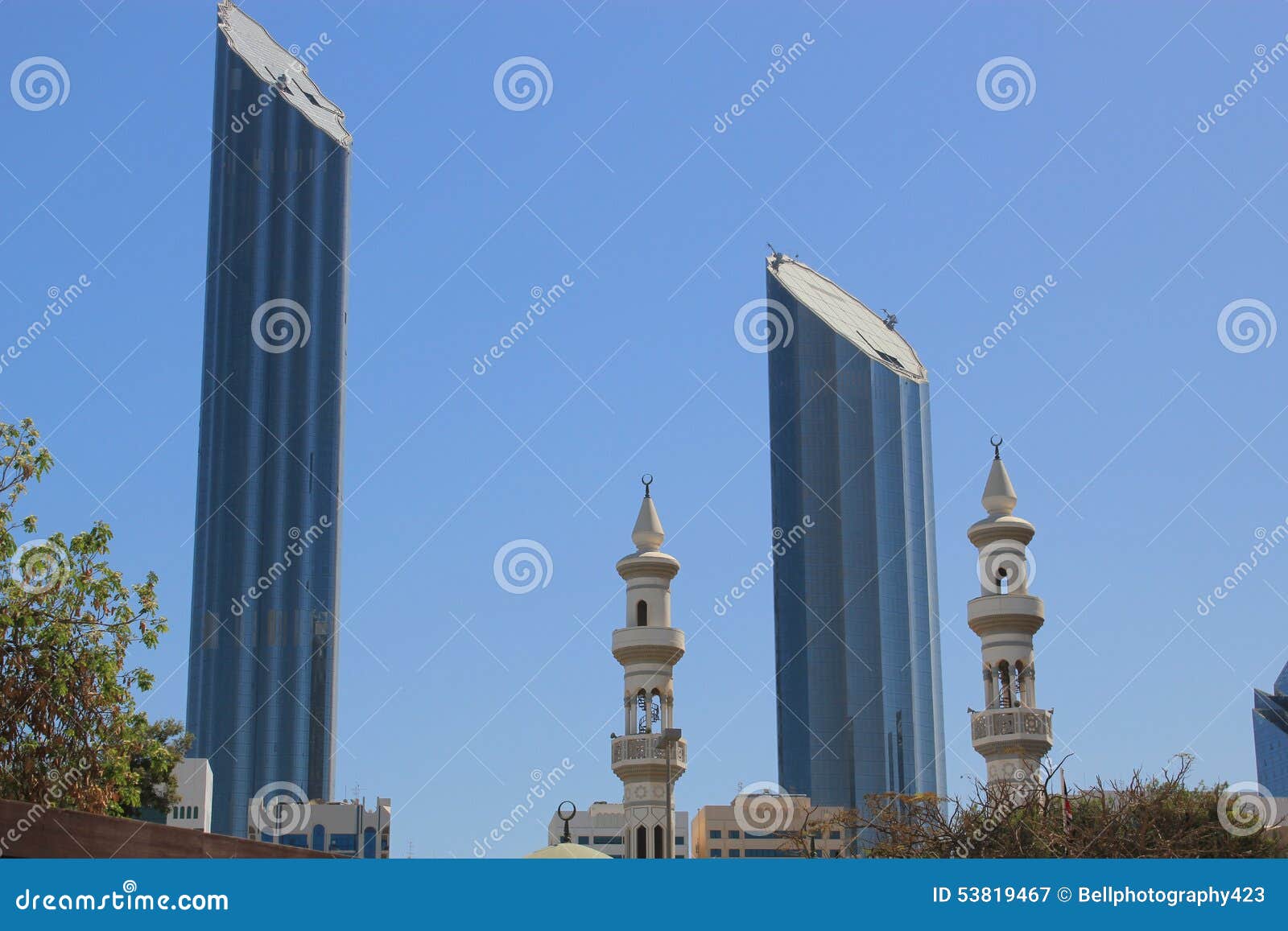 mosque minaretes contrasted with modern skyscrapers