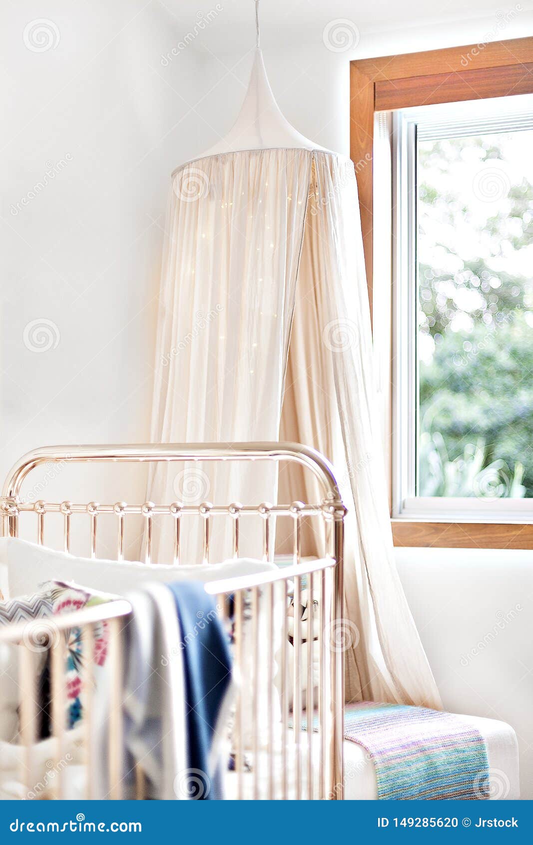 Mosquito Net in a Modern Bedroom with a Baby Bed Stock Photo