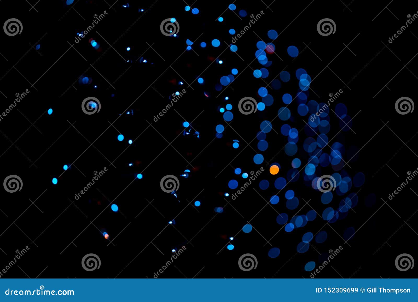 mostly blue lights on a black field in bokeh focus for backgrounds