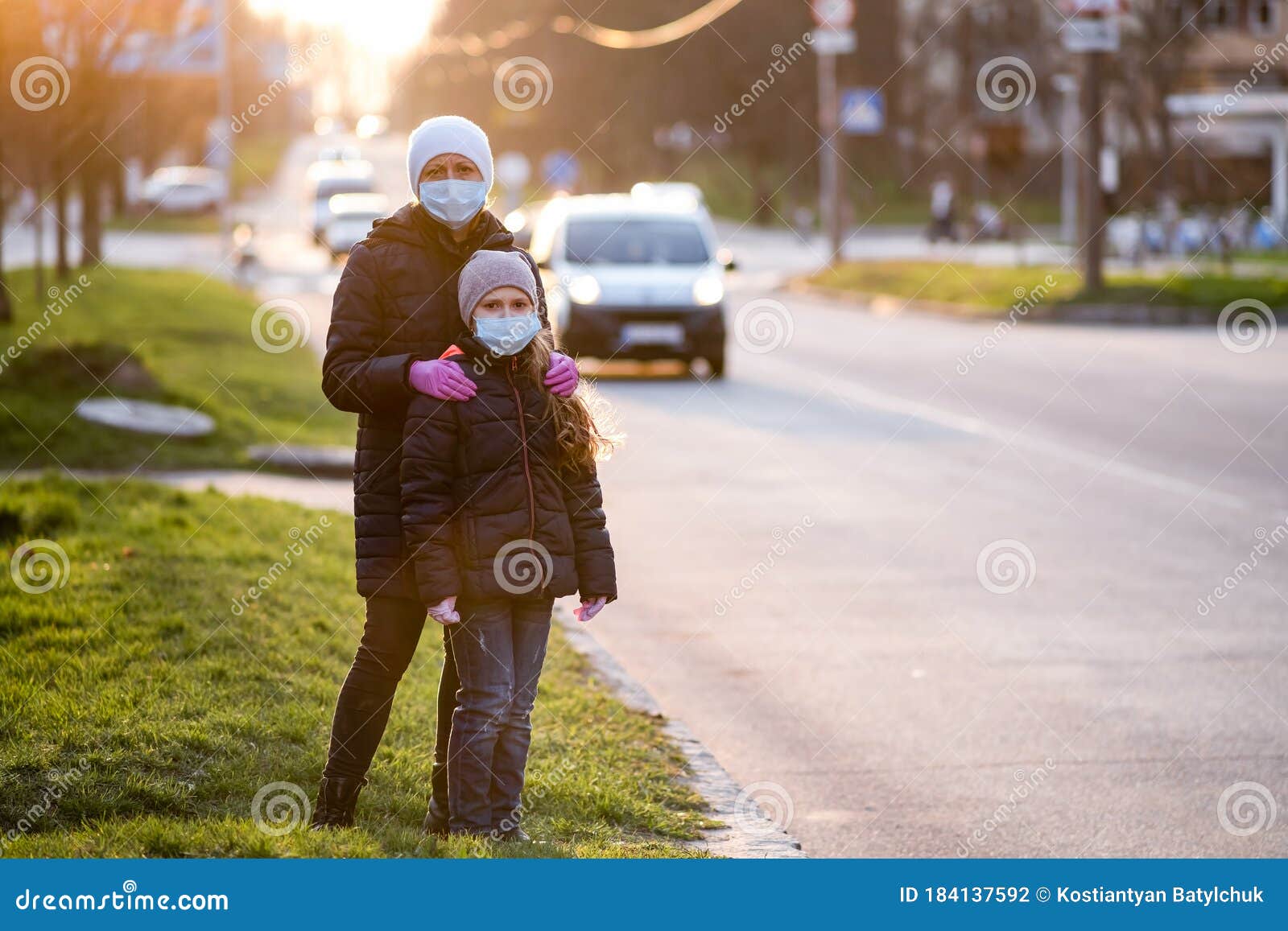 Mother Adjusts Her Daughters Medical Mask On The Street Of A European