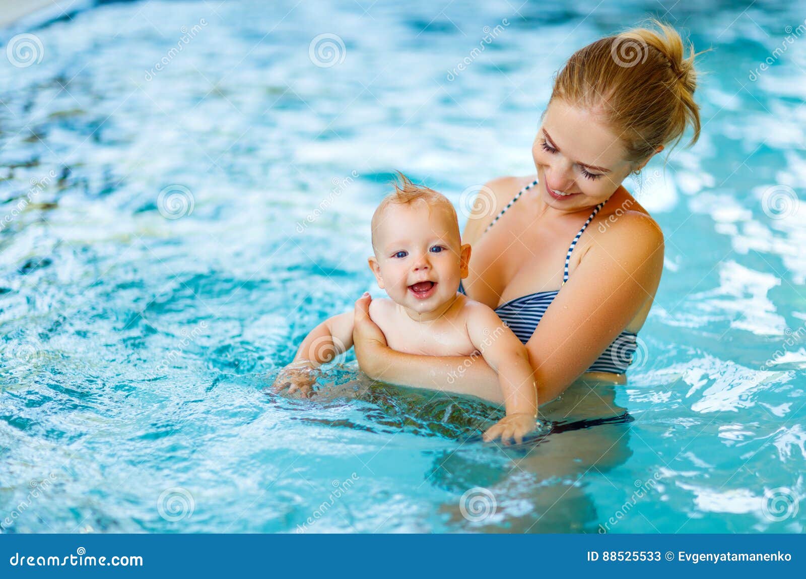 mother and baby swim in pool
