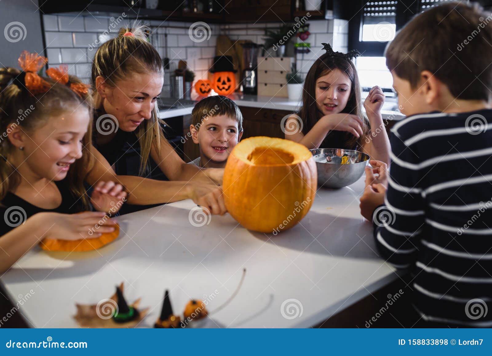 Mother Carving Halloween Pumpkin with Children at Decorated Home ...