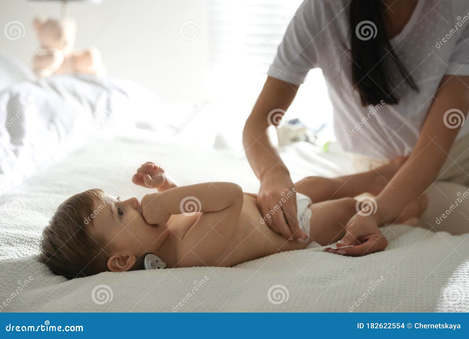 changing baby on bed