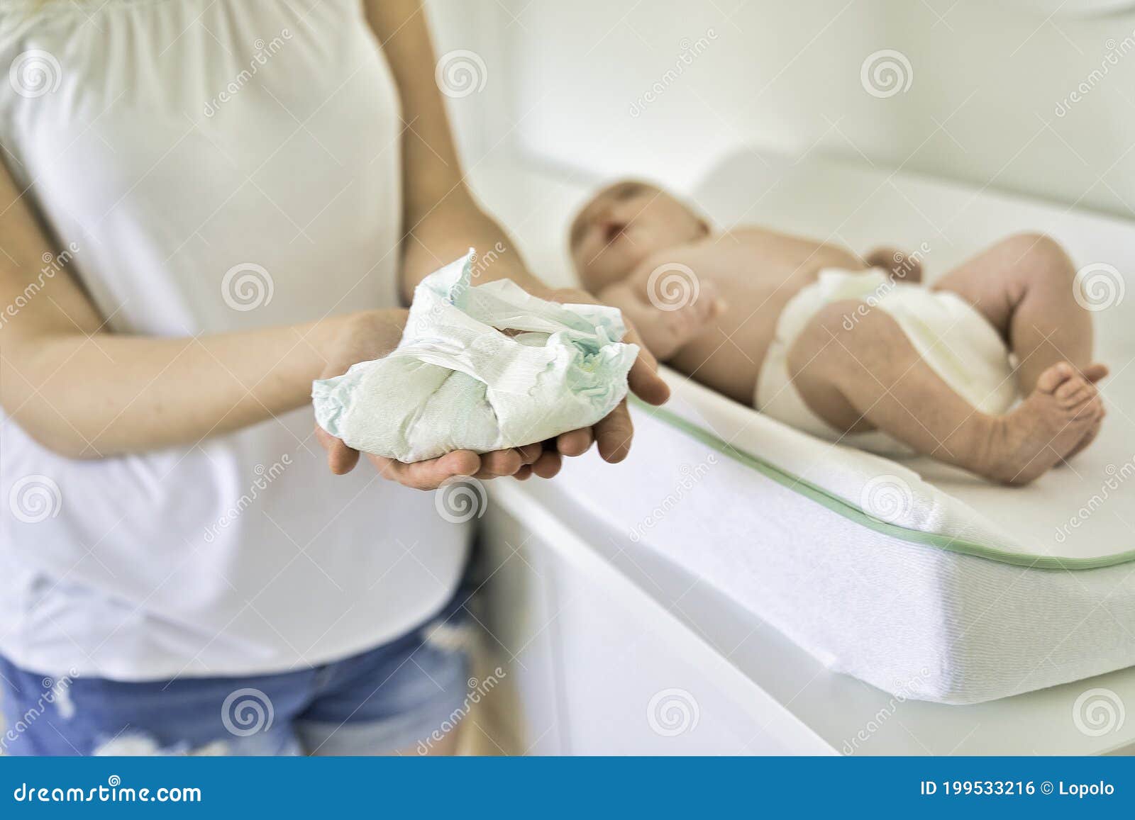 A Mother Changing Baby`s Diaper in Nursery Holding Diaper Stock Photo Image of home