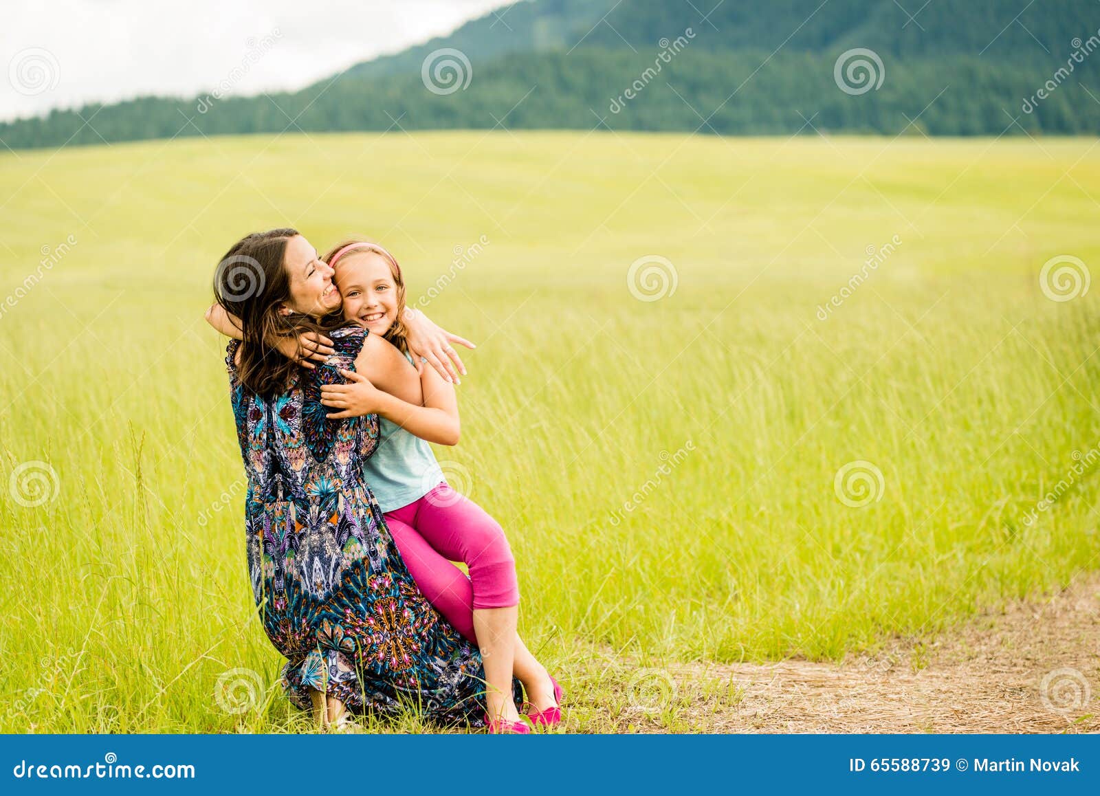 Mother and child embracing stock image. Image of green - 65588739