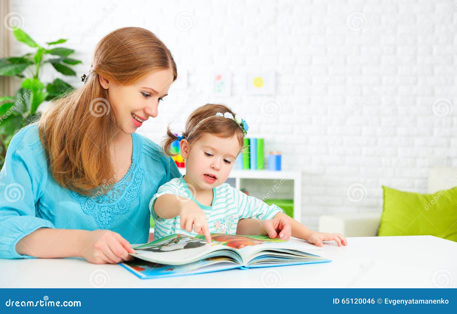 mother and child reading book at home