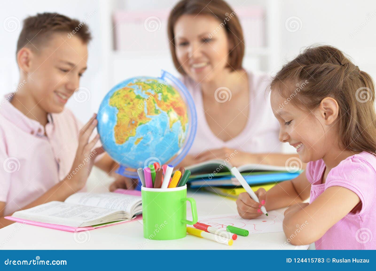 mother with children doing homework at home
