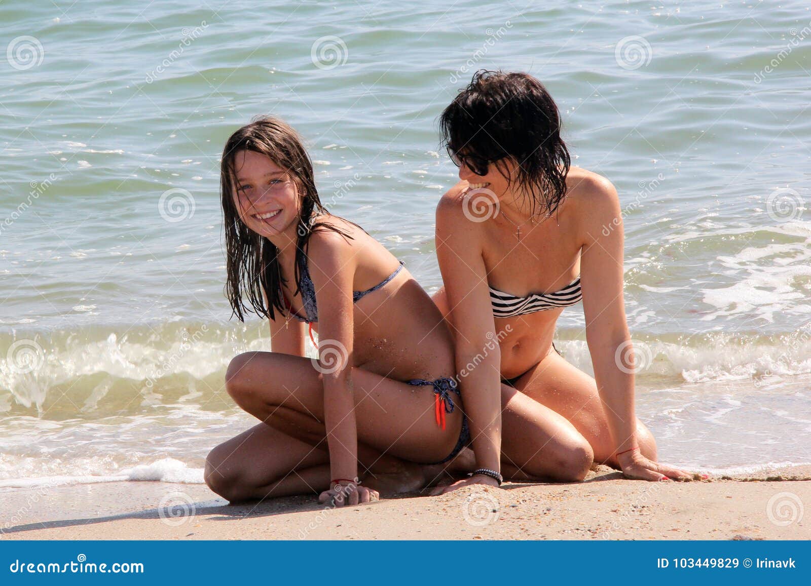 Mother and daughter on nude beach