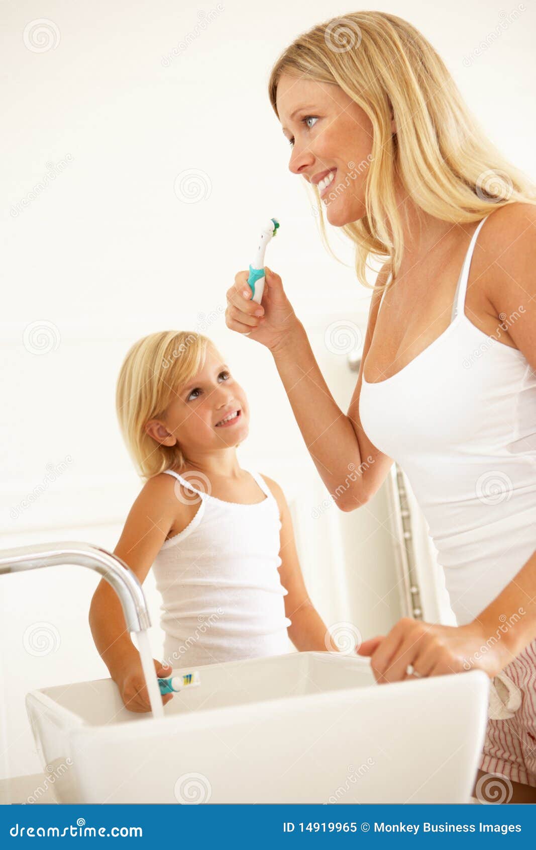 Mother and Daughter Brushing Teeth in Bathroom Stock Image Image of