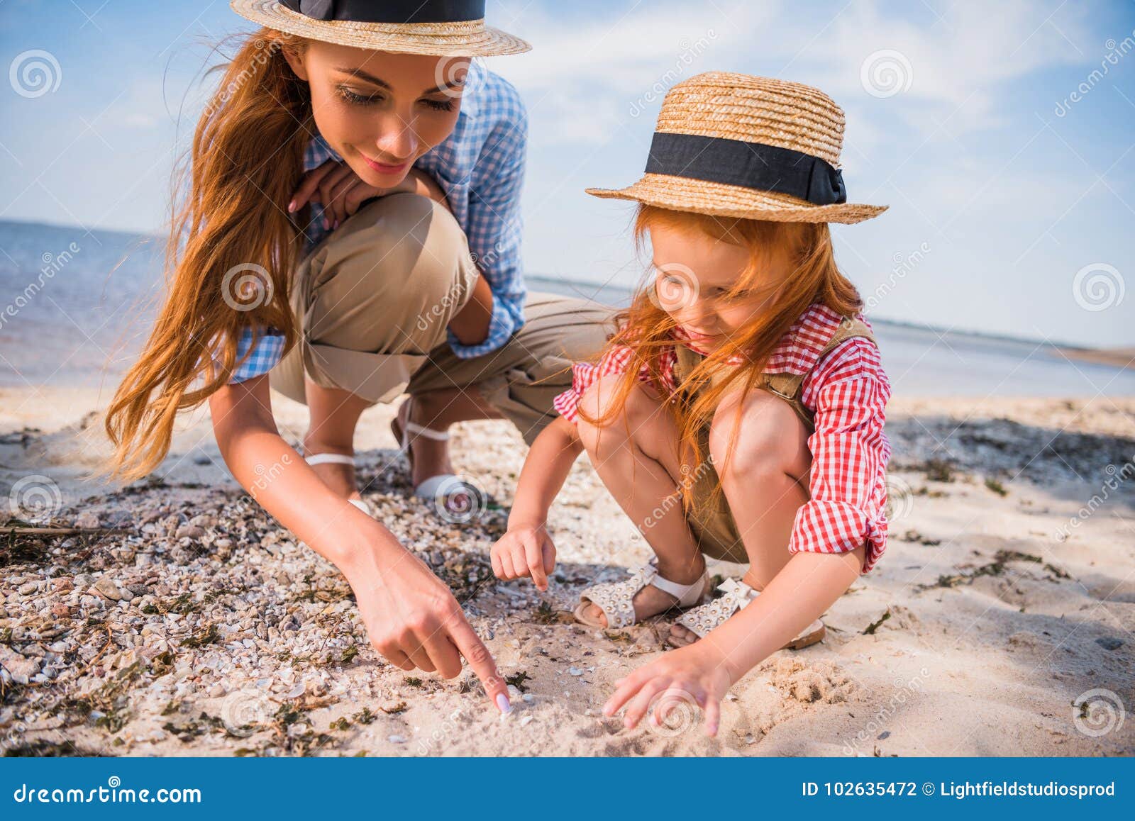 mother and daughter collecting seashells