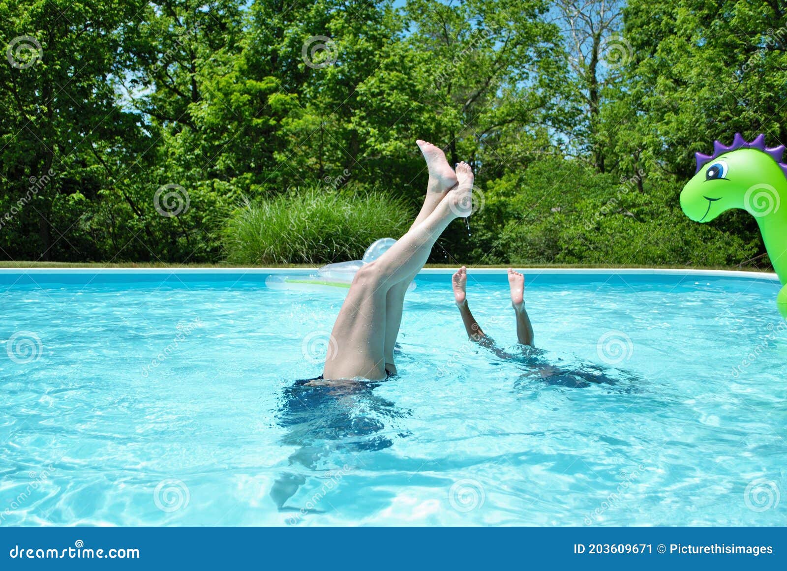mother and daughter doing handstands in the pool