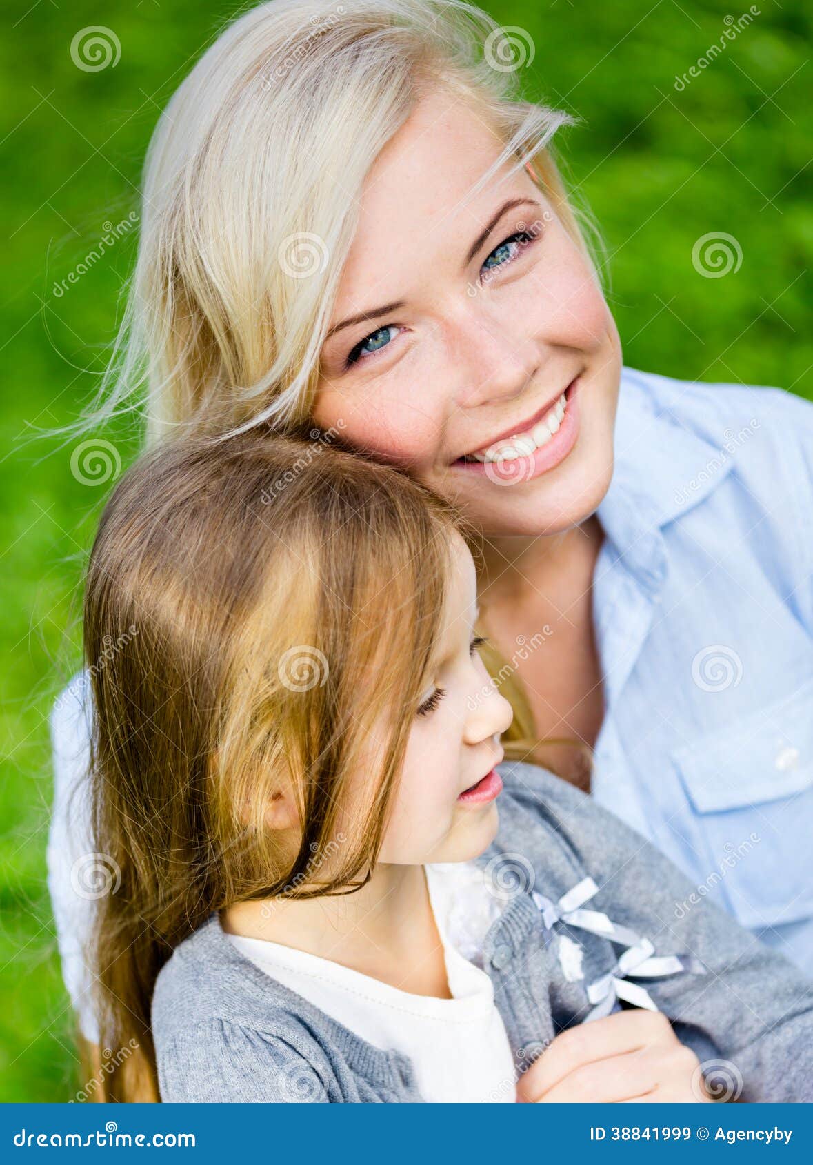 Mother And Daughter Embrace Each Other On The Grass Stock Image Image 