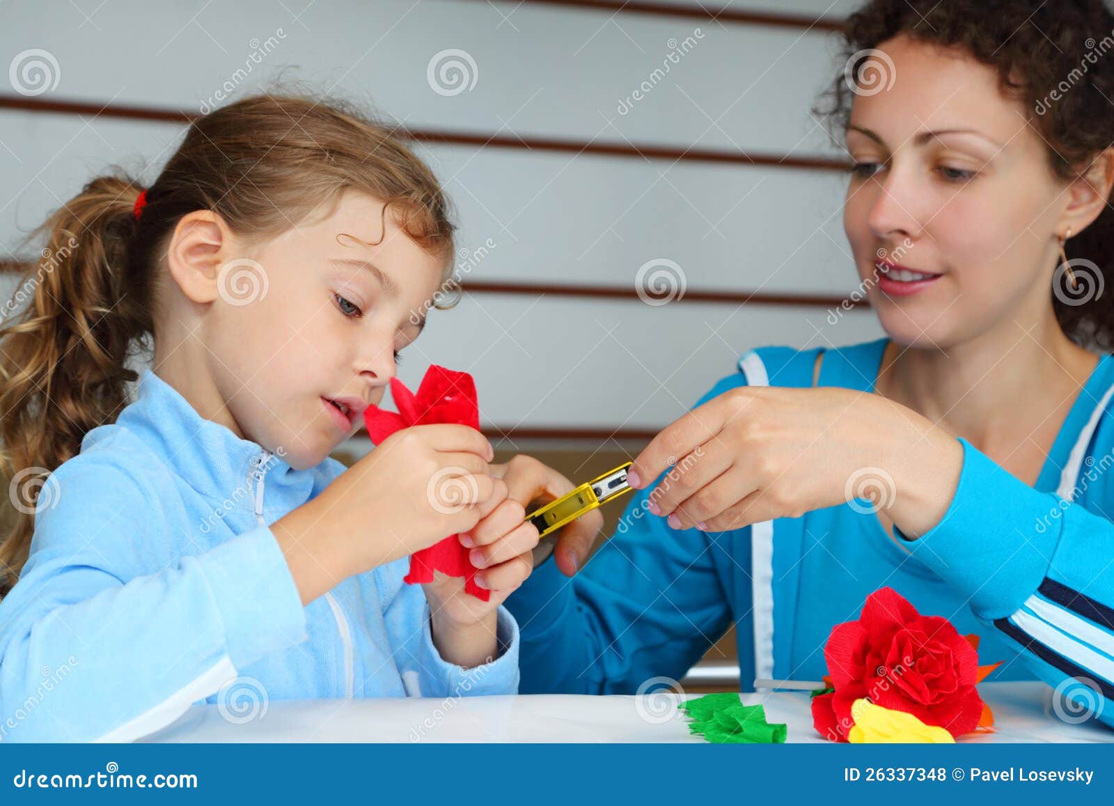 mother and daughter make artificial roses
