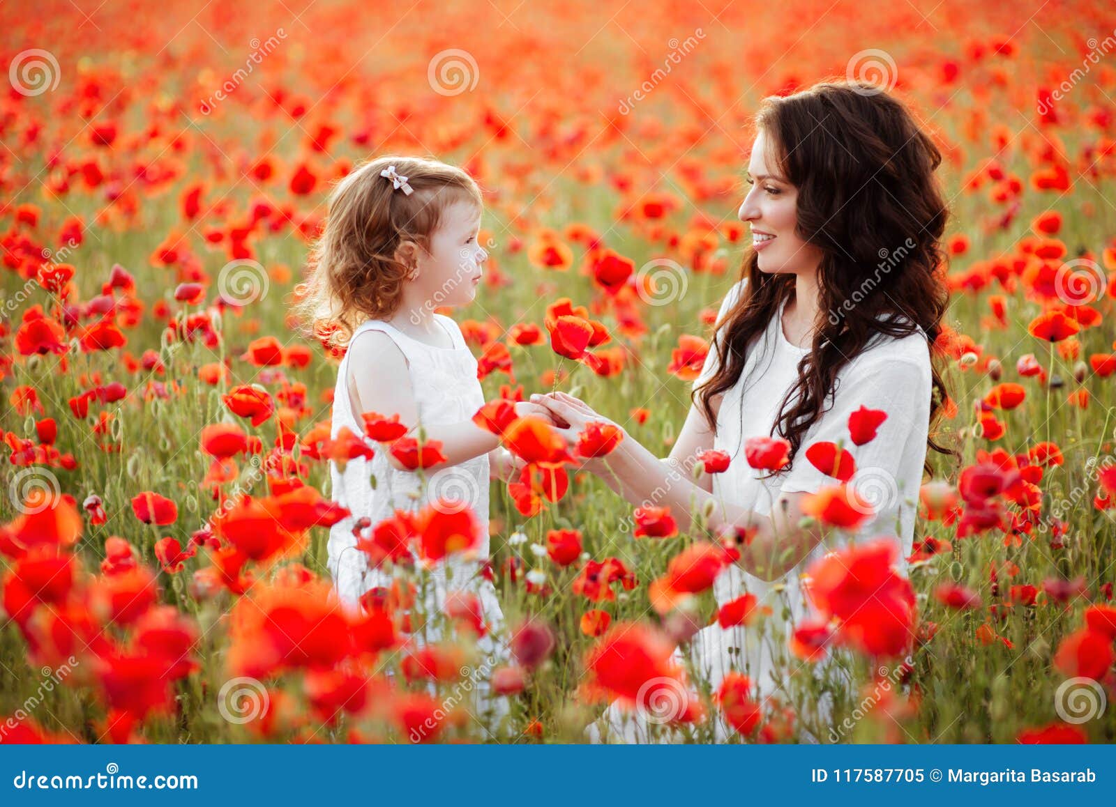 The Eldest Daughter Walks Down The Flower Path Mother and Daughter Playing in Flower Field Stock Image - Image of