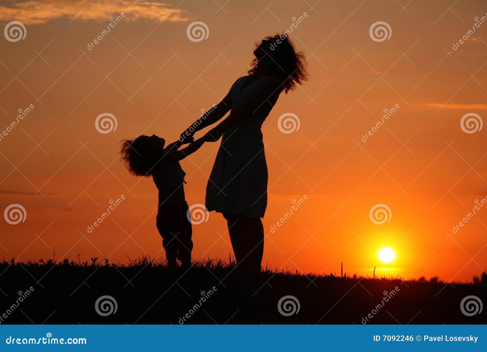 mother and daughter on sunset watching on sky