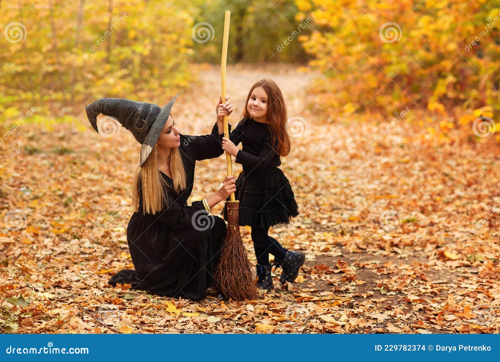 Mother and Daughter Sweeping Path on Halloween Day Stock Photo - Image ...