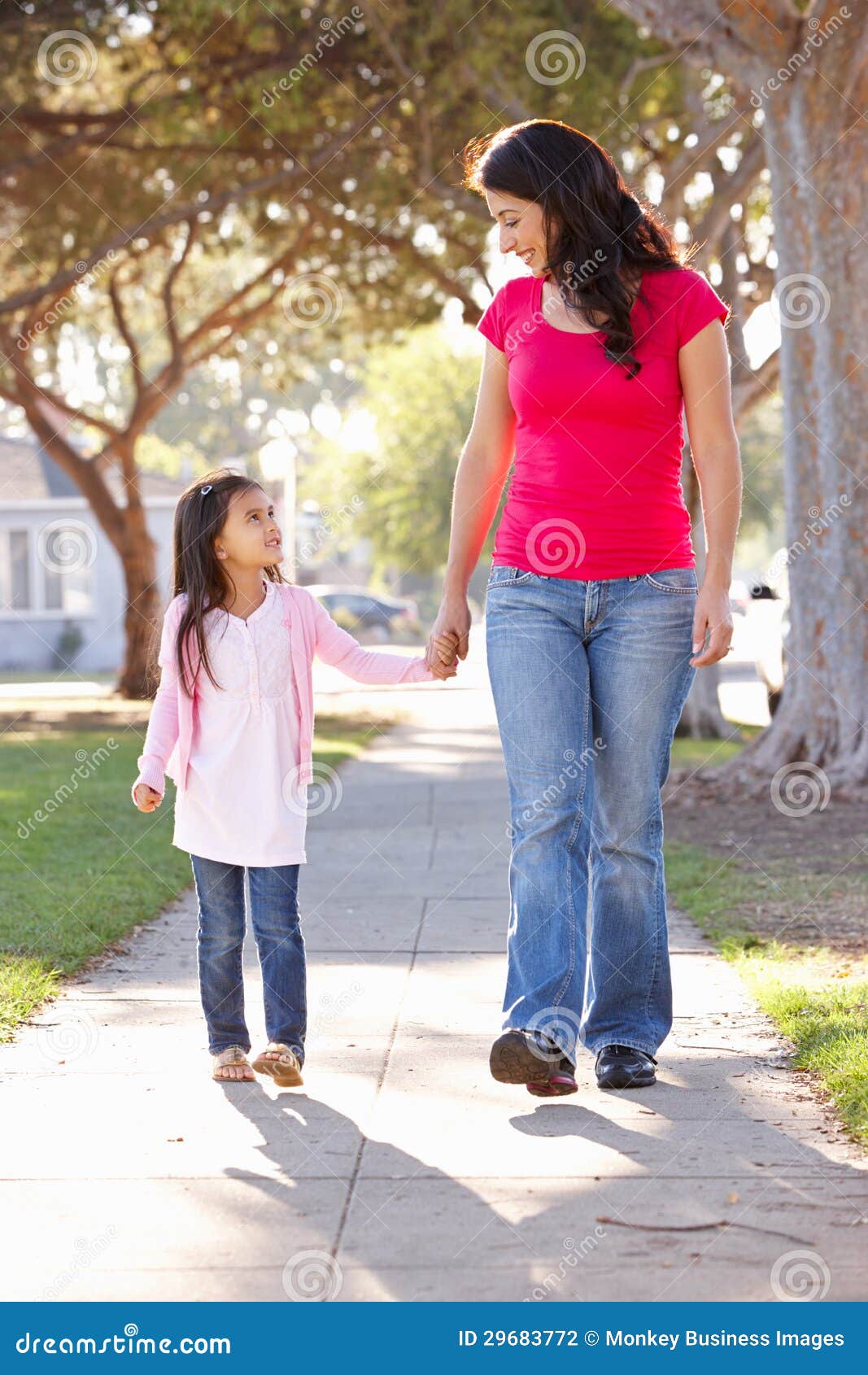 Mom And Daughter Walking Through The Orchards In Bloom Stock