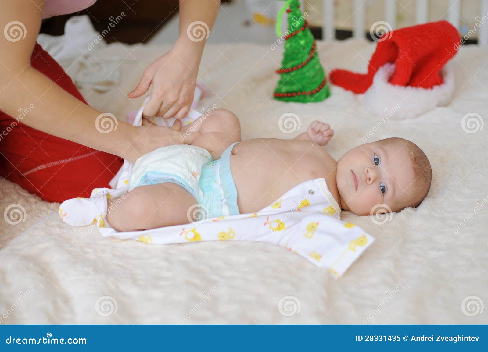 Mother Dressing Baby stock image. Image of happiness 28331435