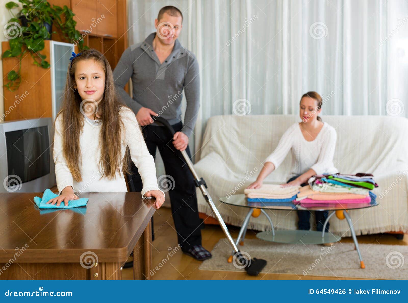 Mother, Father and Girl Doing General Cleaning Stock Photo