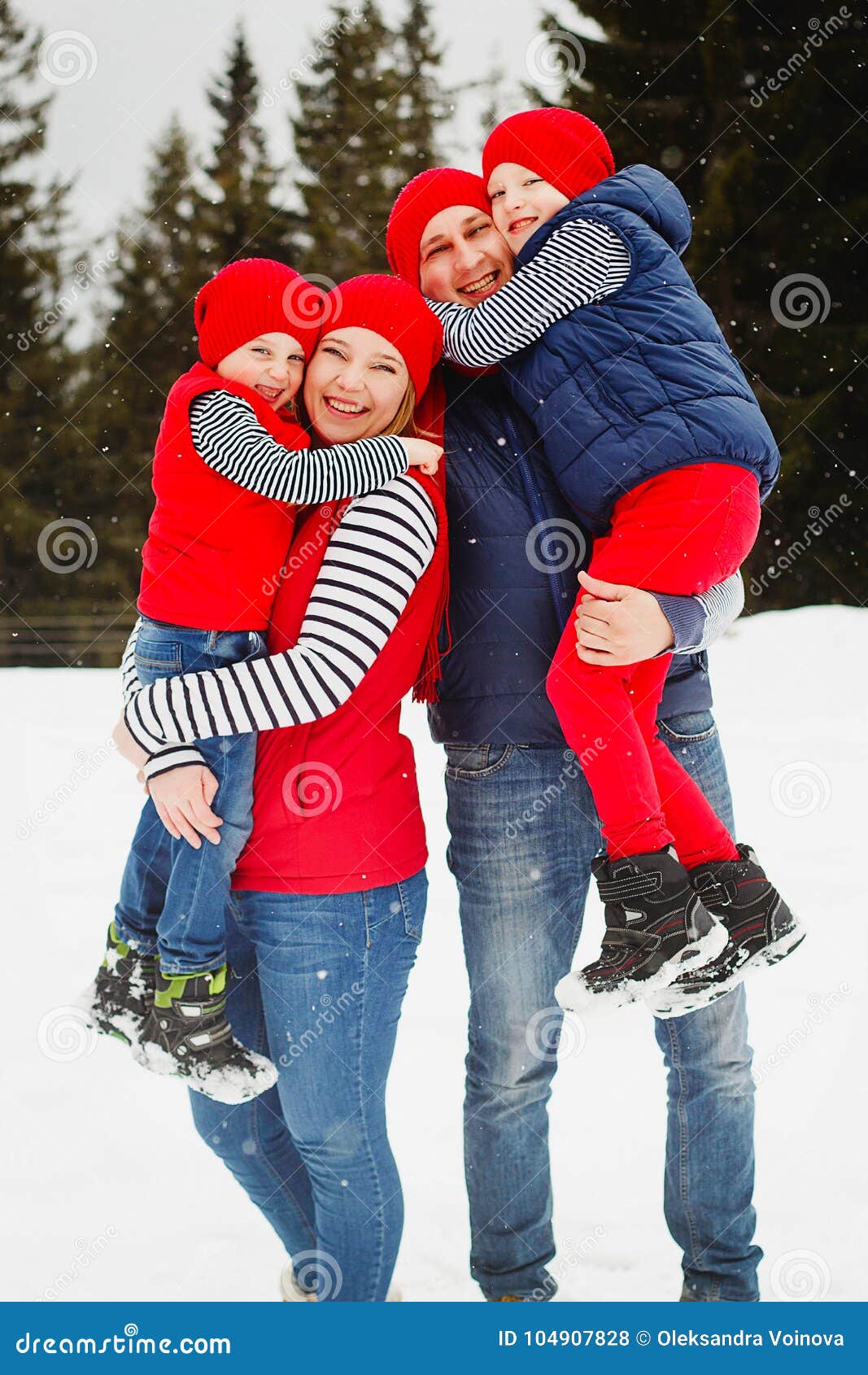Mother, Father and Two Sons Having Fun in Snow Winter Stock Photo