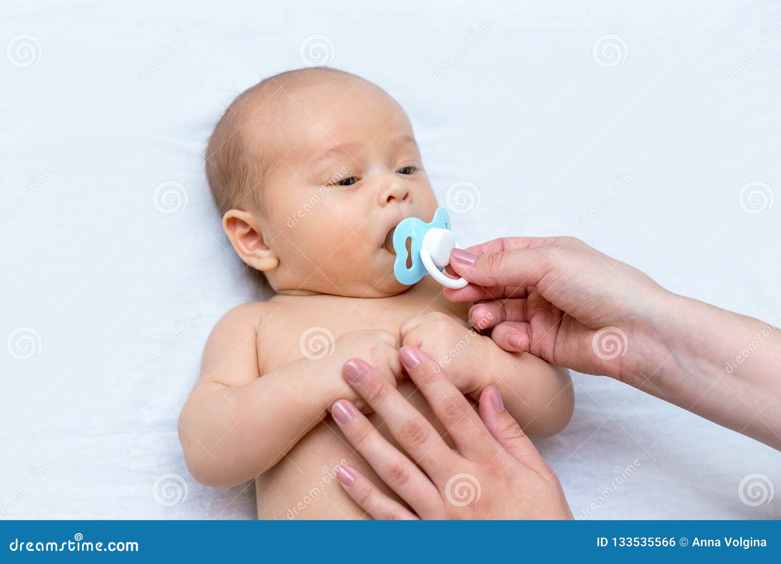 giving a newborn a pacifier